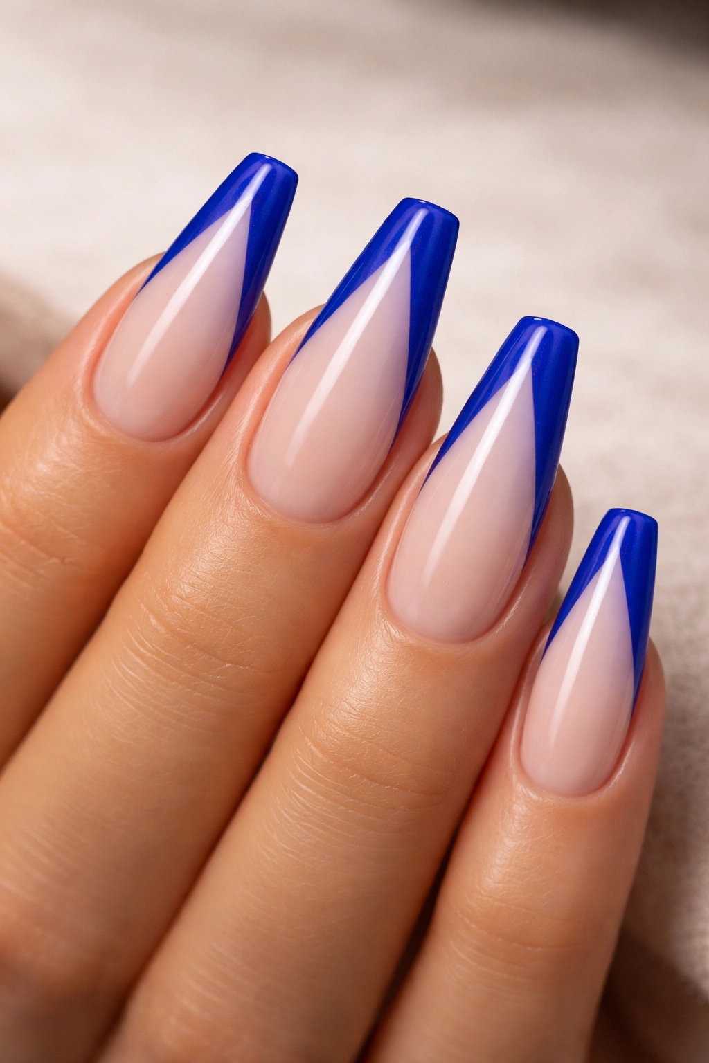 Cobalt V-tip on mid-length ballerina nail forming a sharp V
