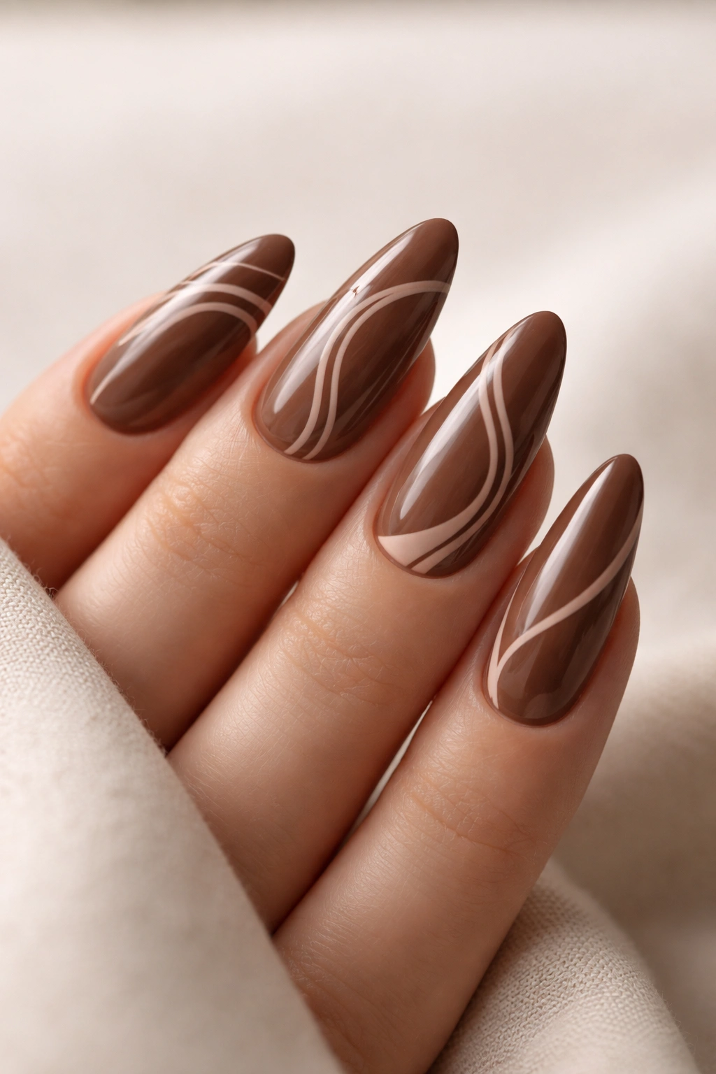 Cocoa almond nails with nude swirls and negative space