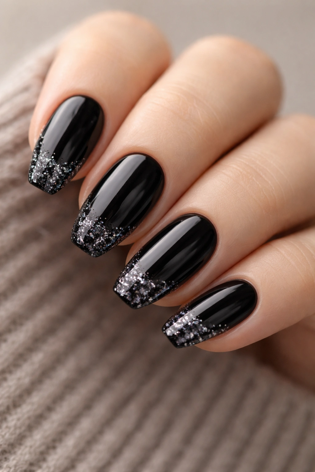 Short almond nails with black base and squared glitter tips