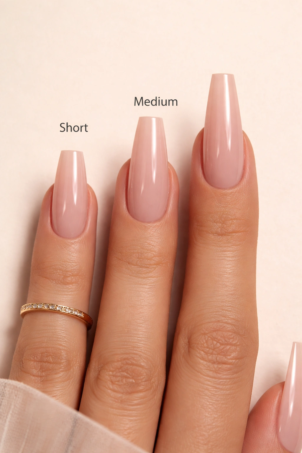 Coffin nails in short, medium, and long lengths on one hand.