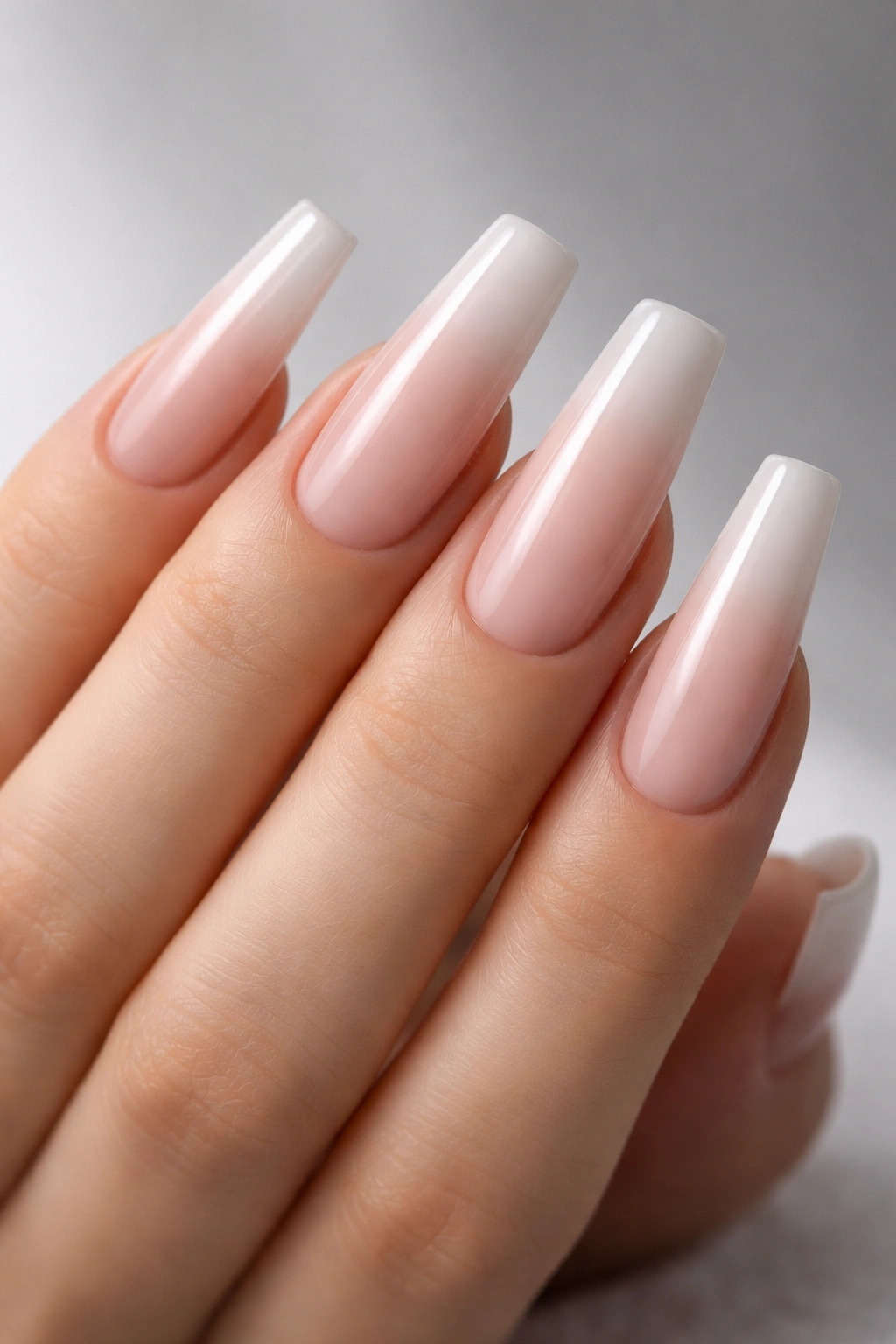 Close-up of a hand with long coffin nails featuring flat squared-off tips and a glossy manicure