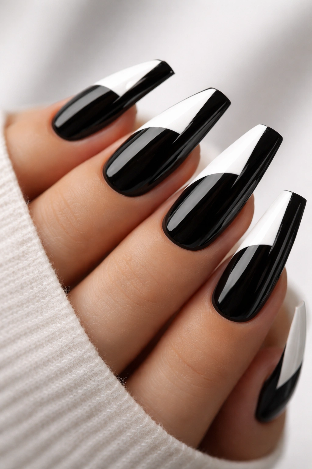 Close-up of coffin nails with a bold black-and-white diagonal split