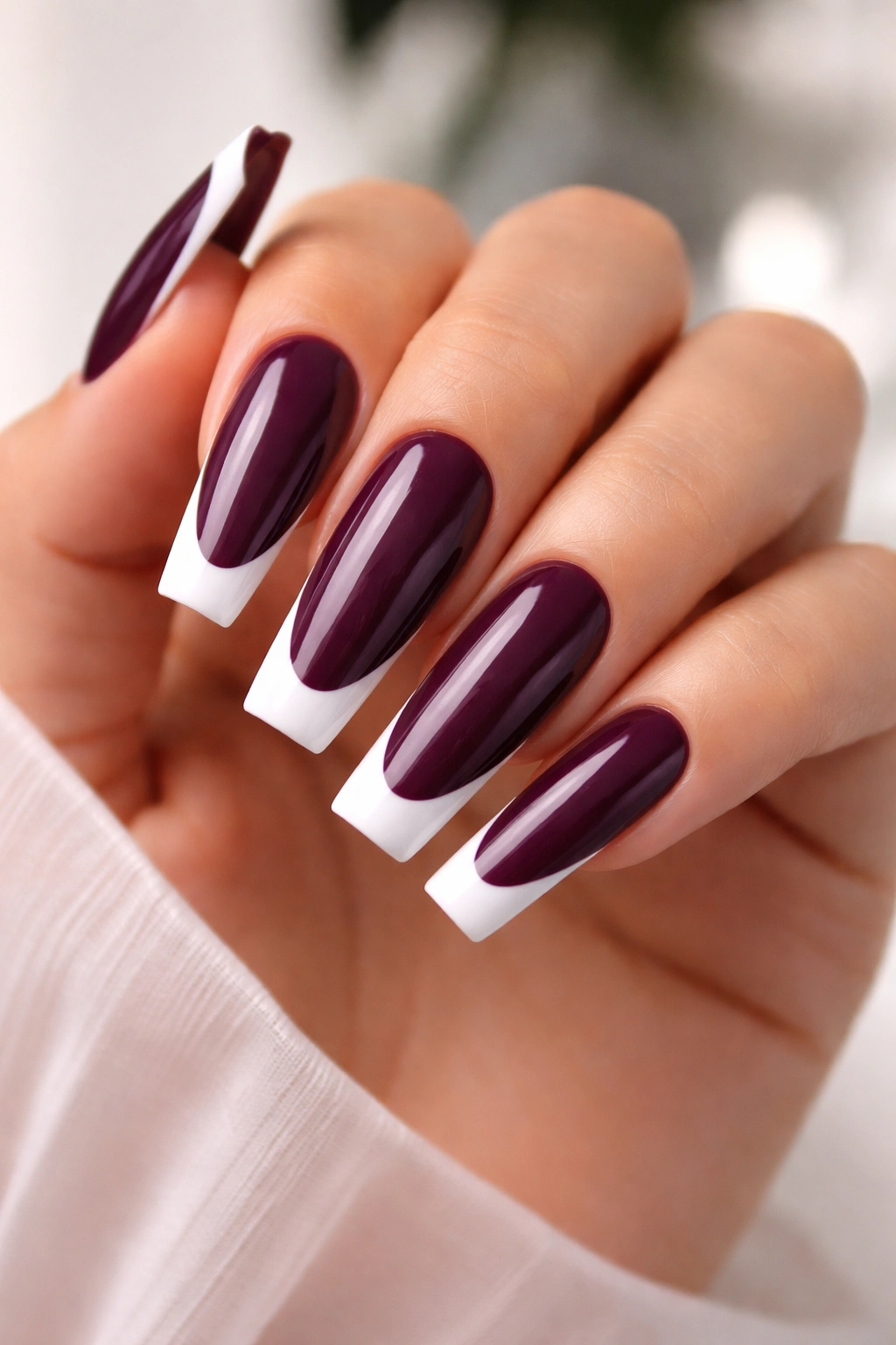 Close-up of plum coffin nails with white French tips