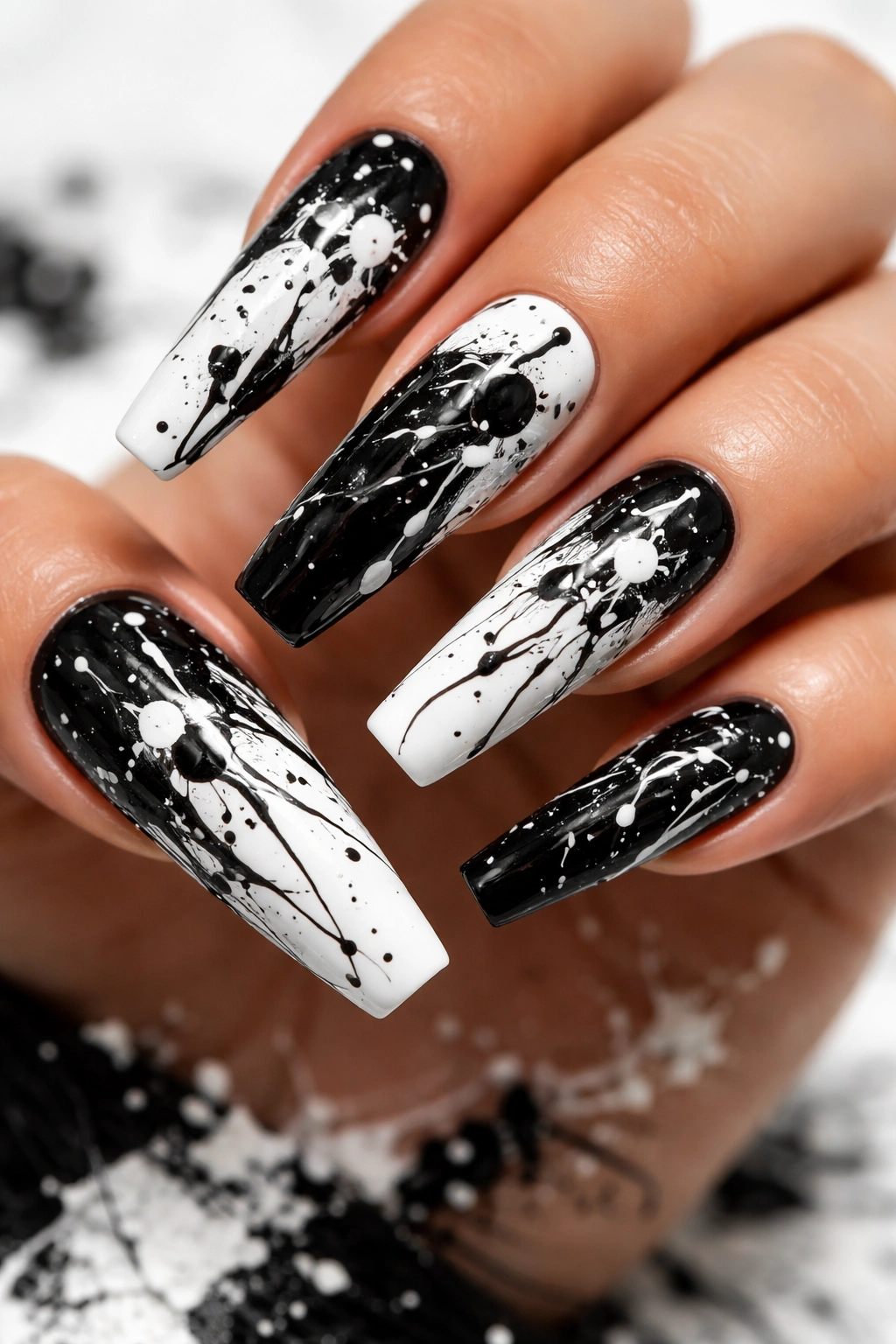 Close-up of coffin nails with black and white splatter abstract pattern
