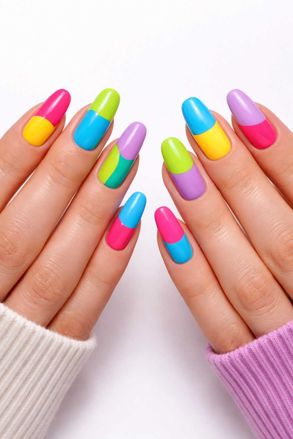Hands with bold color-blocked nails in cohesive palette