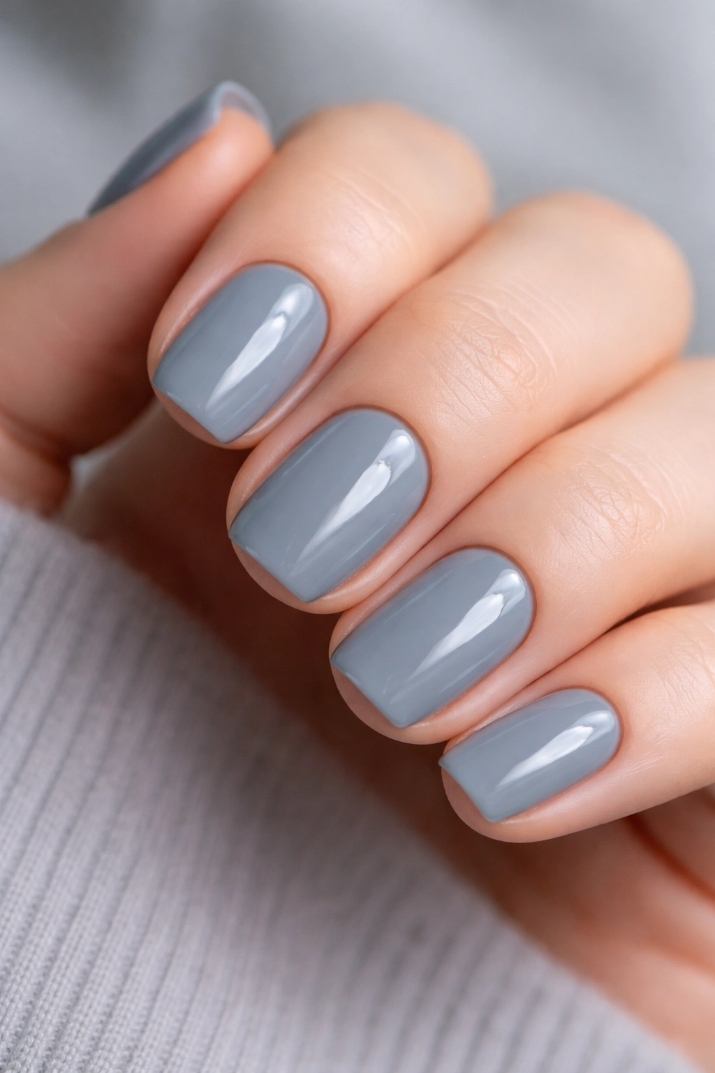 Close-up of short squoval nails in cool gray with blue undertones