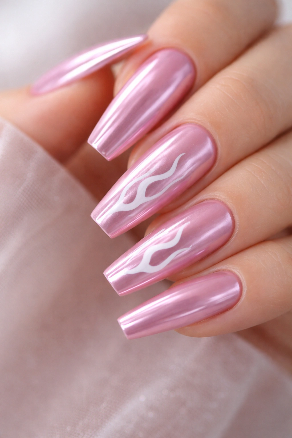 Cool pink chrome nails with white flame accents on a ballerina shape