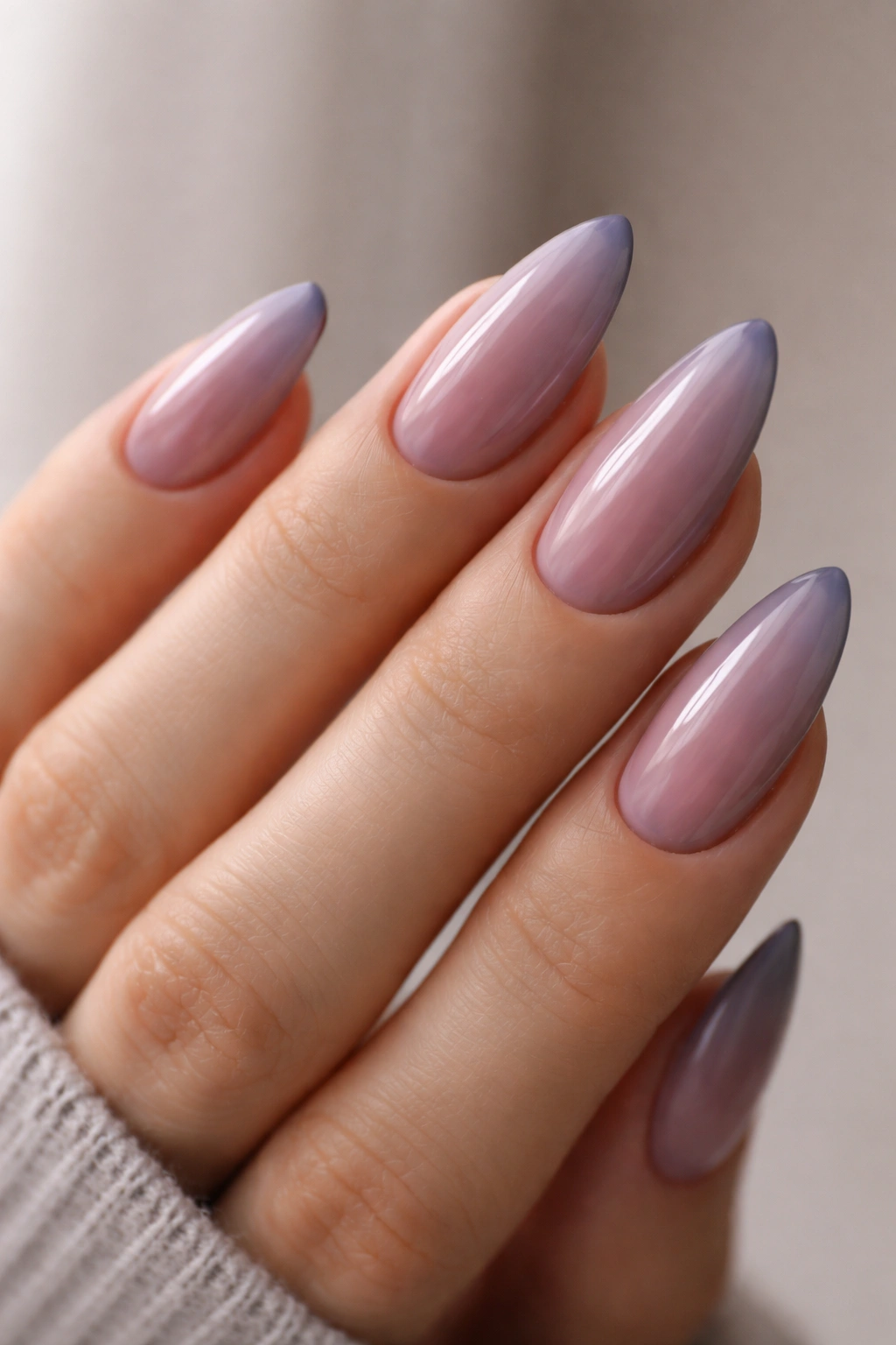 Close-up of cool rose almond nails with mauve undertones