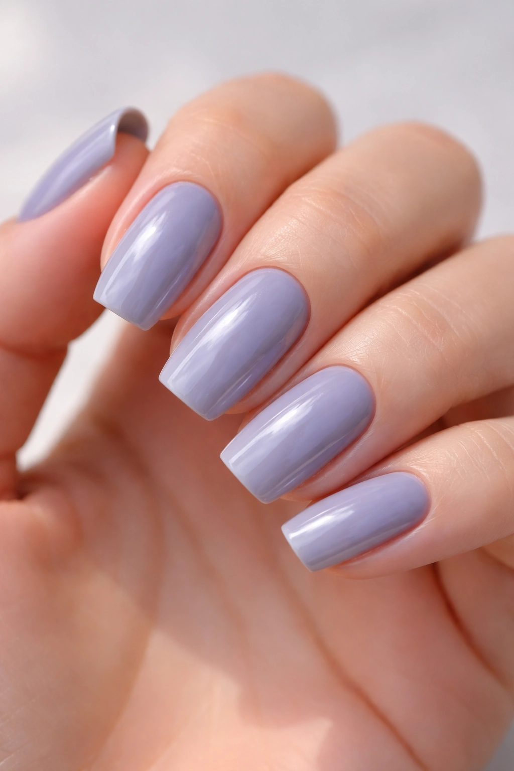 Close-up of nails with cool-toned grey and subtle lavender undertones