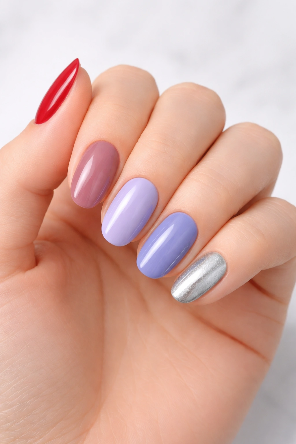 Nails painted in cool-toned shades such as blue-based red, lavender, and silver