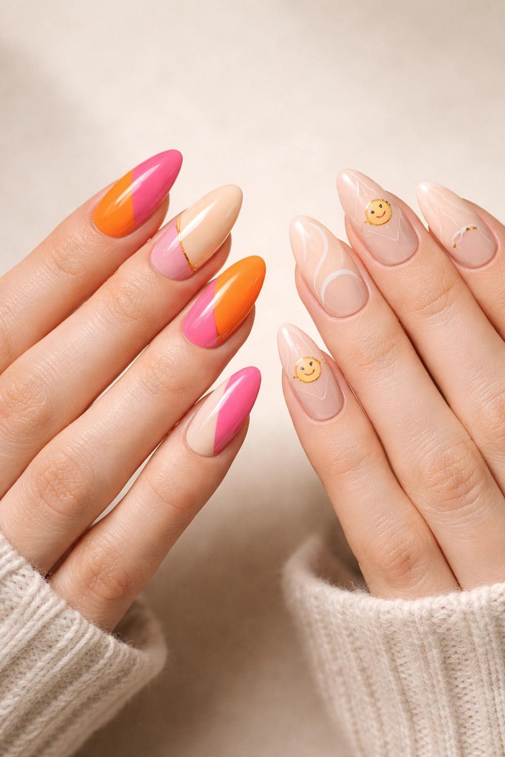 Close-up of two hands with almond nails in coordinating designs including color blocking, line art, and smiley motifs