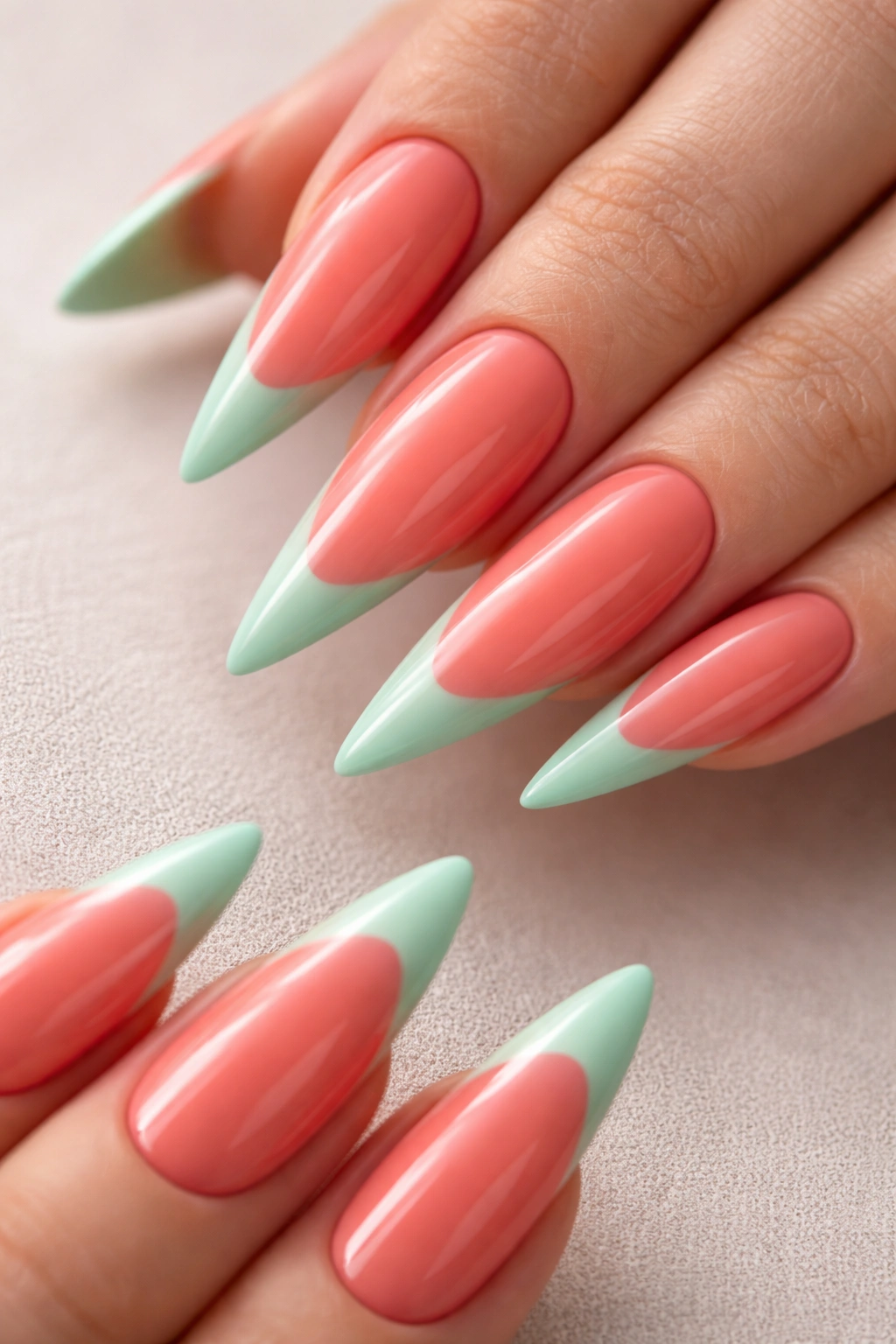 Coral stiletto nails with mint green tips