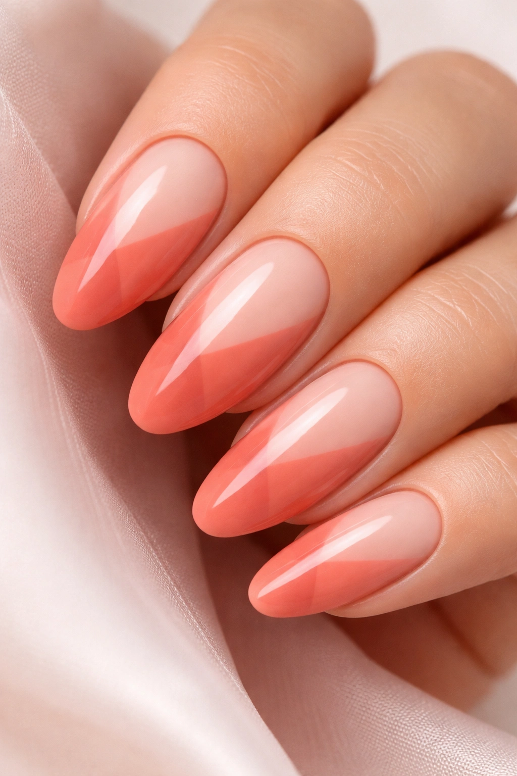 Coral nude nails with geometric gradient on long ovals