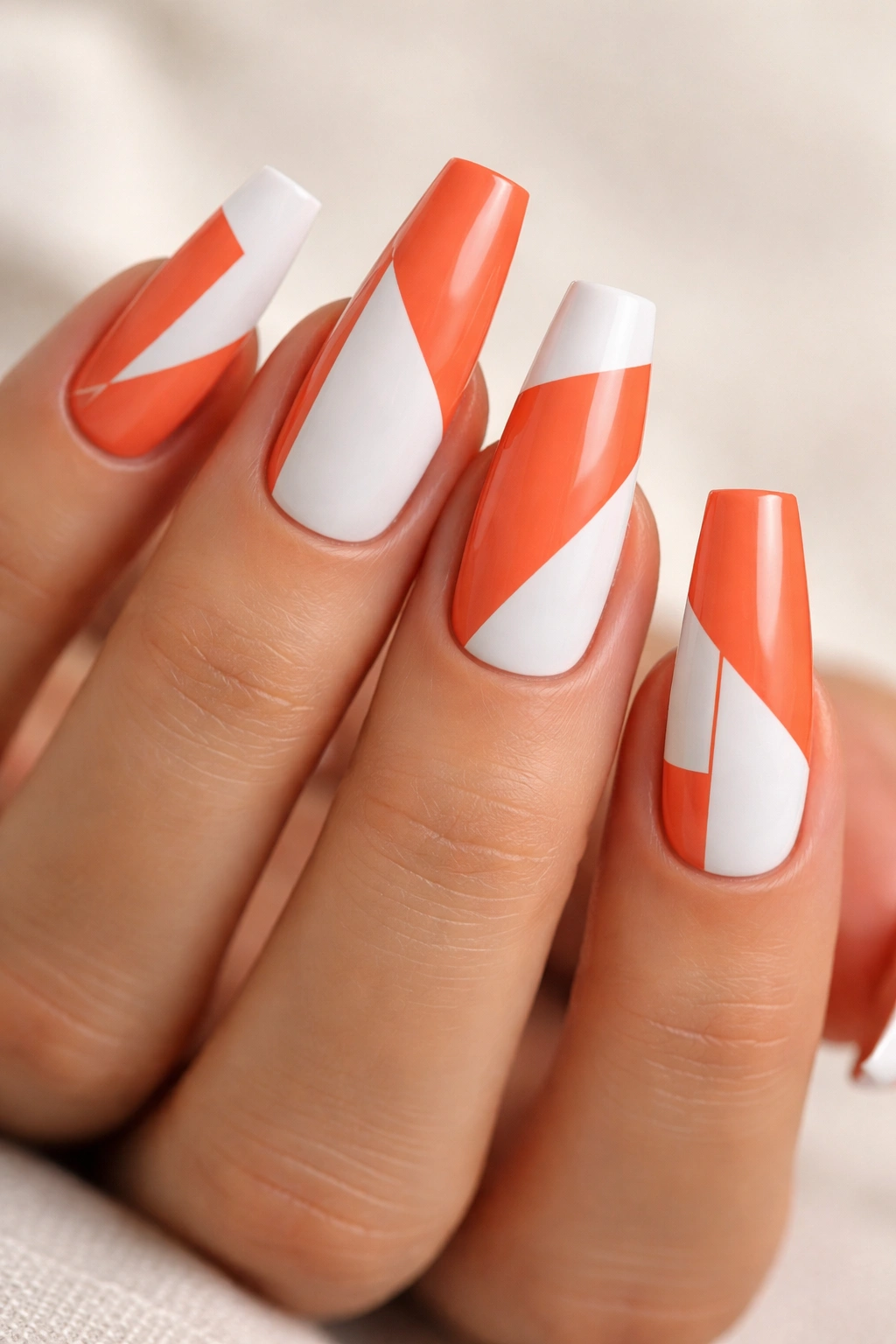 Coffin nails in coral orange with white geometric blocks