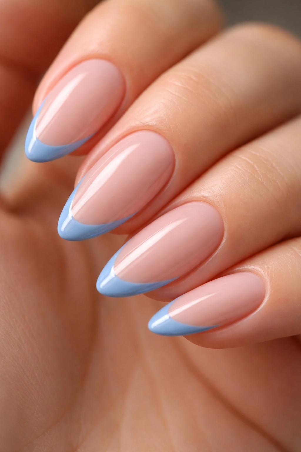 Close-up of almond nails with cornflower blue and single thin French tip