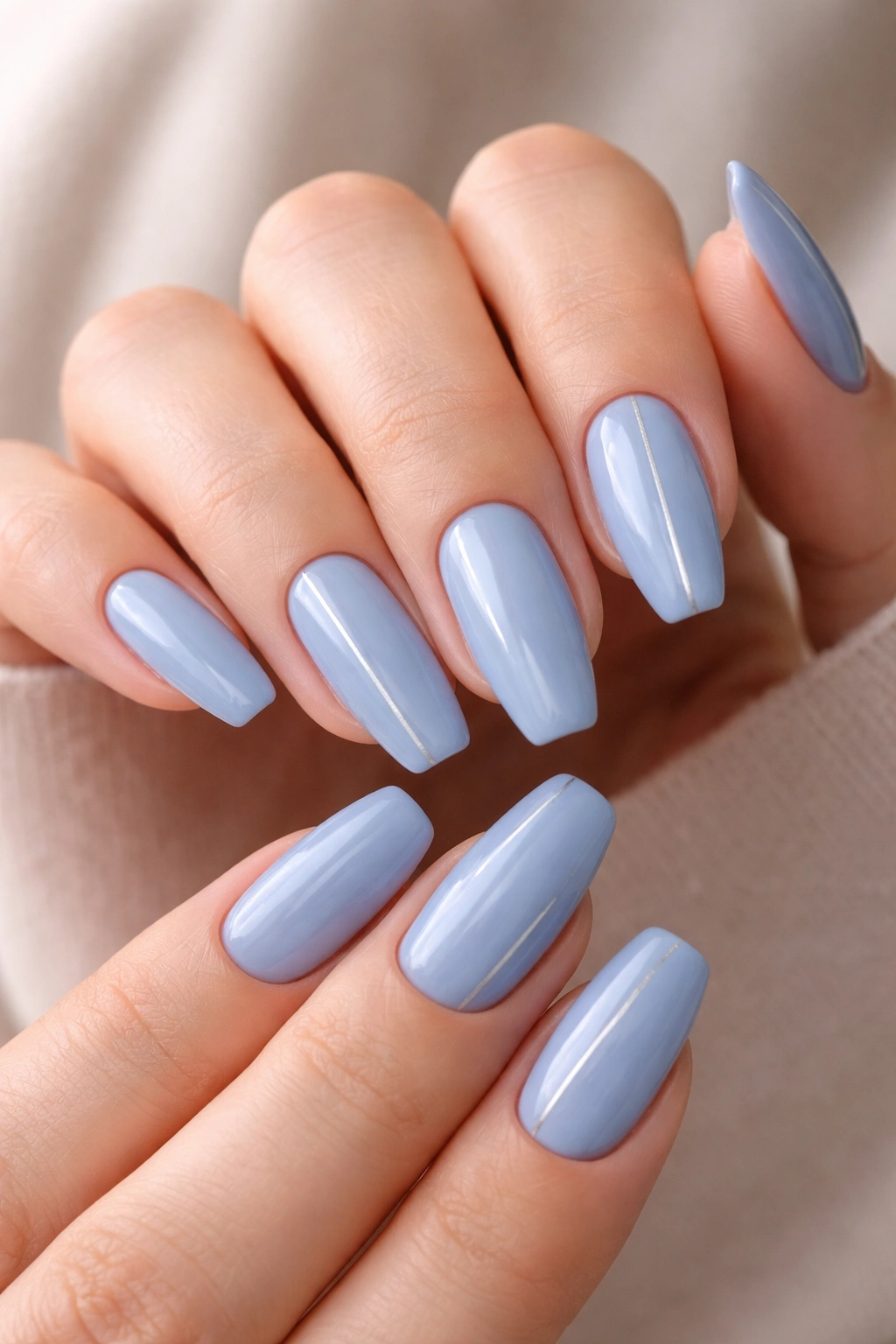 Cornflower blue nails with thin silver lines on two nails per hand