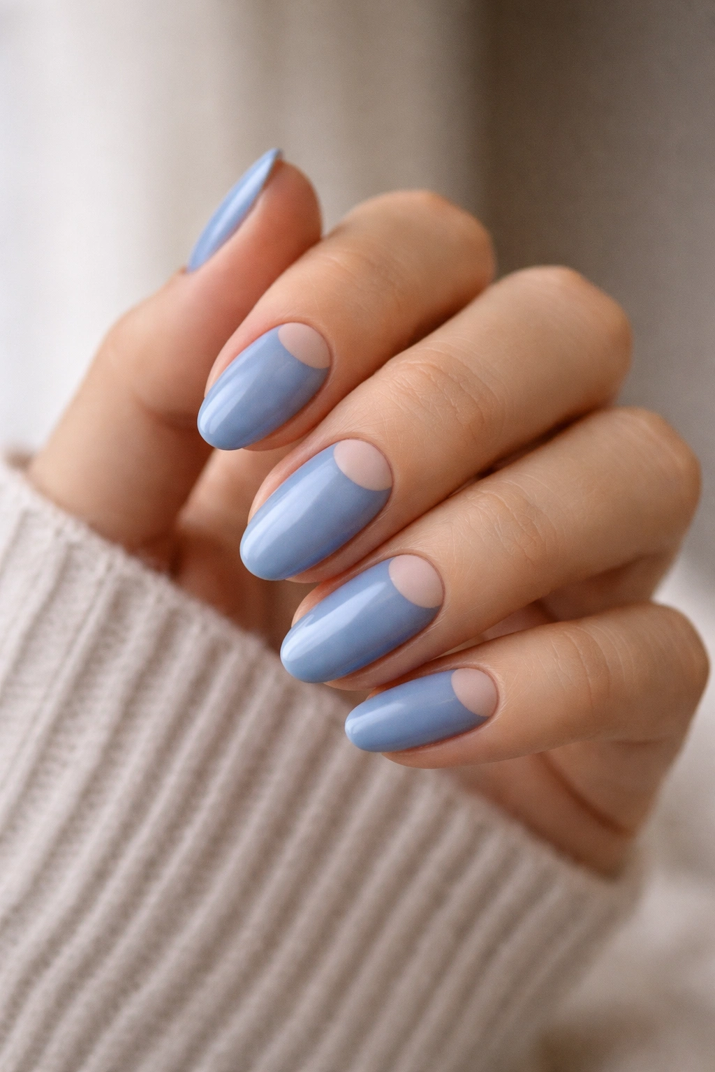 Short almond nails with cornflower blue and nude half-moon near cuticle