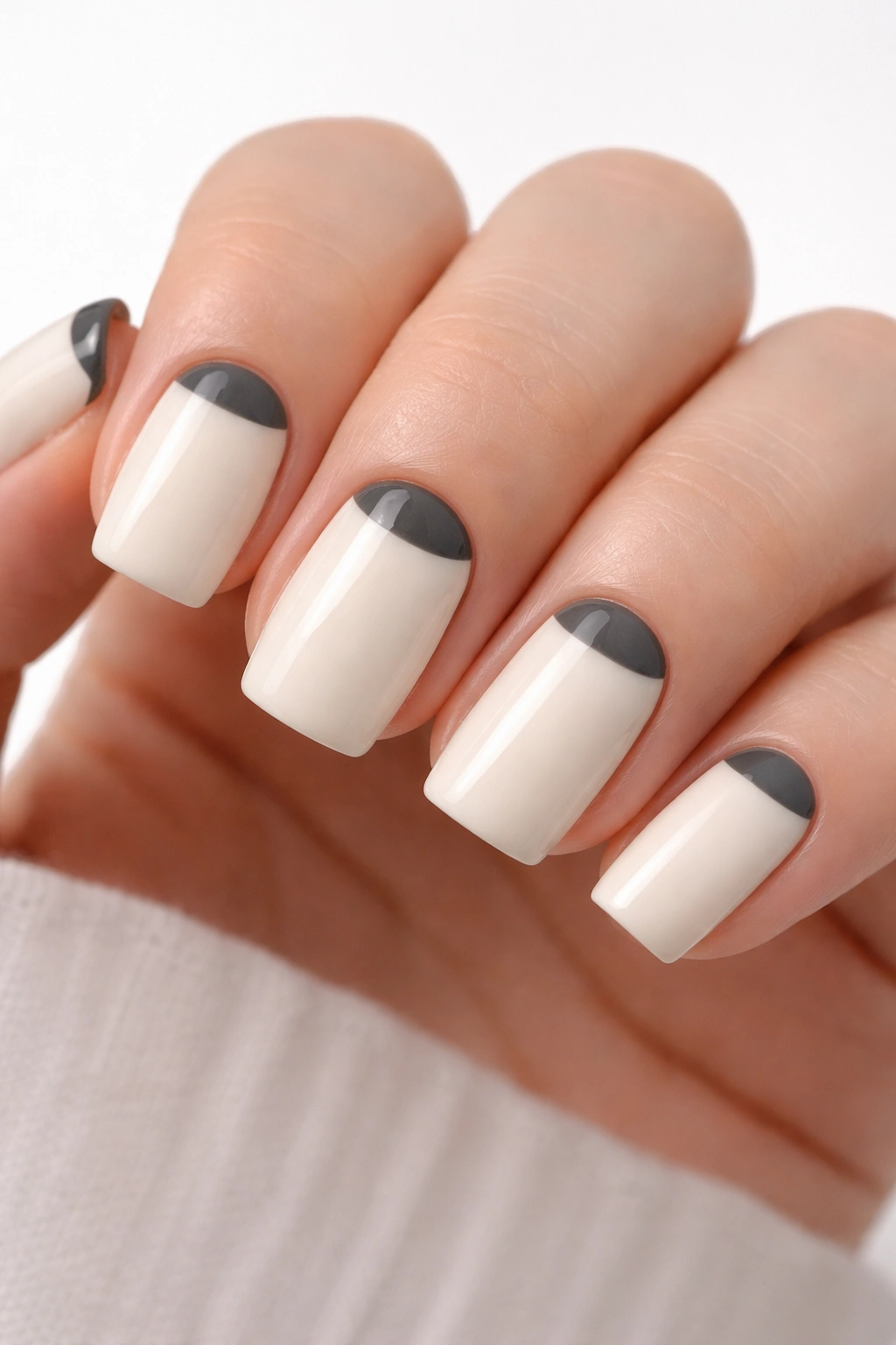Off-white nails with charcoal gray half-moon bases
