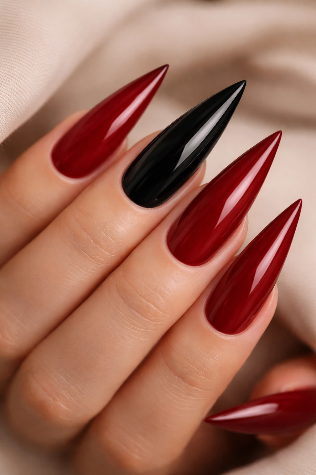 Crimson red stiletto nails with jet black accent nails