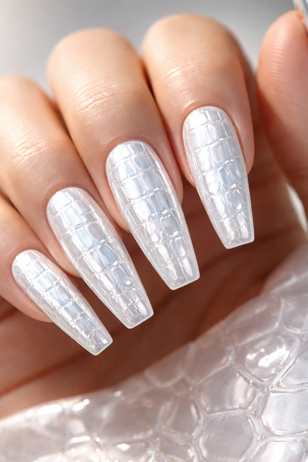 Croc-embossed white chrome nails on long ballerina shape
