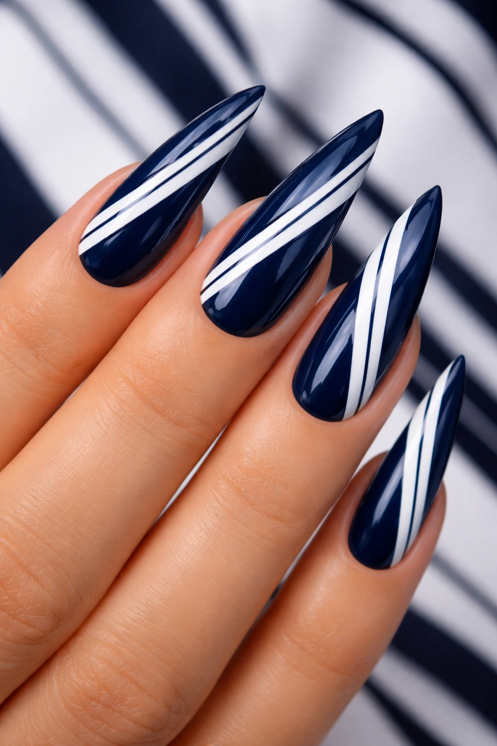 Dark blue nails with white striped pattern on stiletto nails