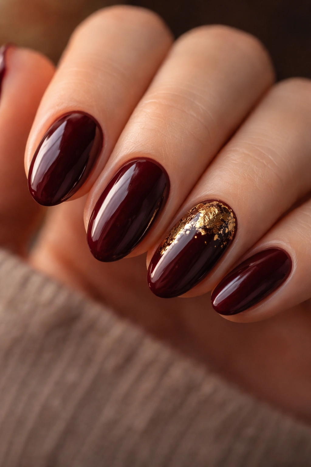 Dark cherry nails with gold foil on short almond shape