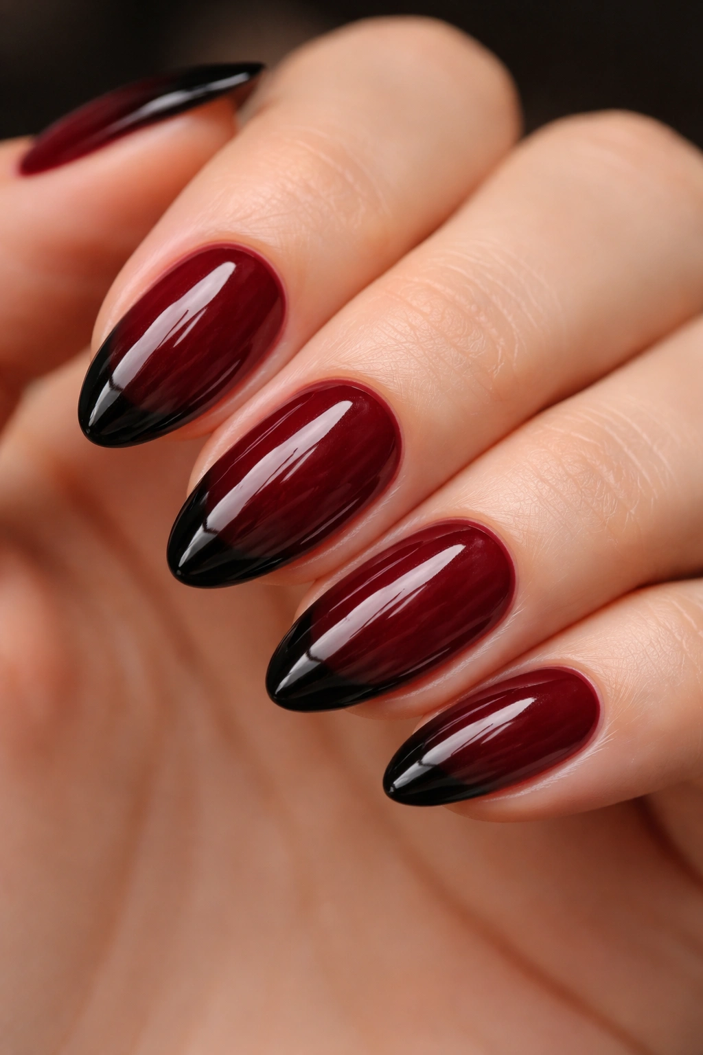 Short almond nails with dark cherry base and black tips
