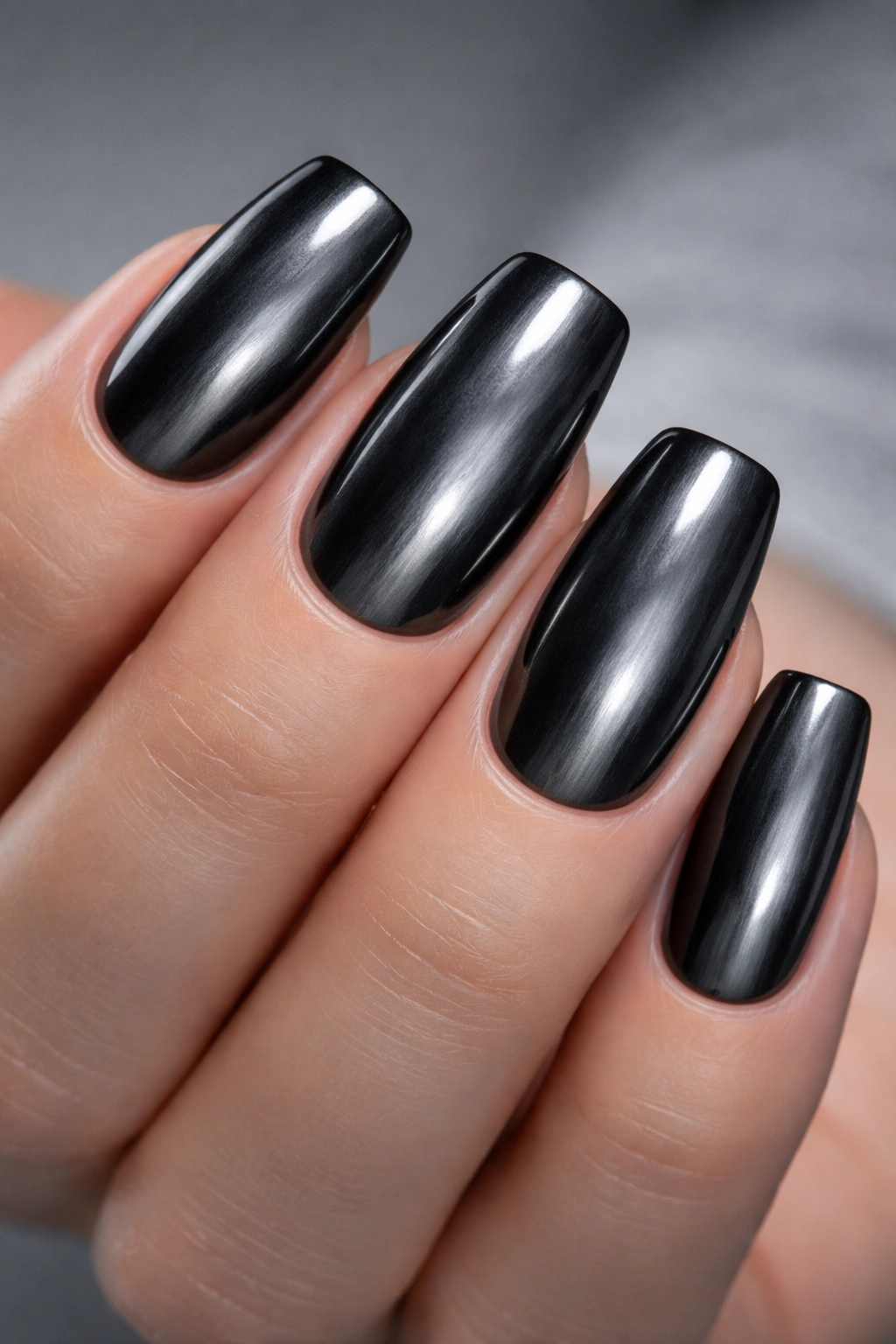 Dark gray chrome nails with soft pearly metallic glow.