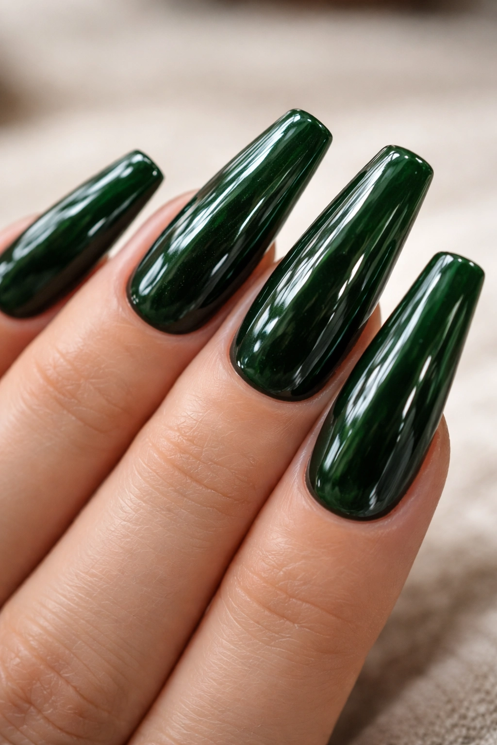 Close-up of dark green coffin nails with a thick glass-like clear overlay