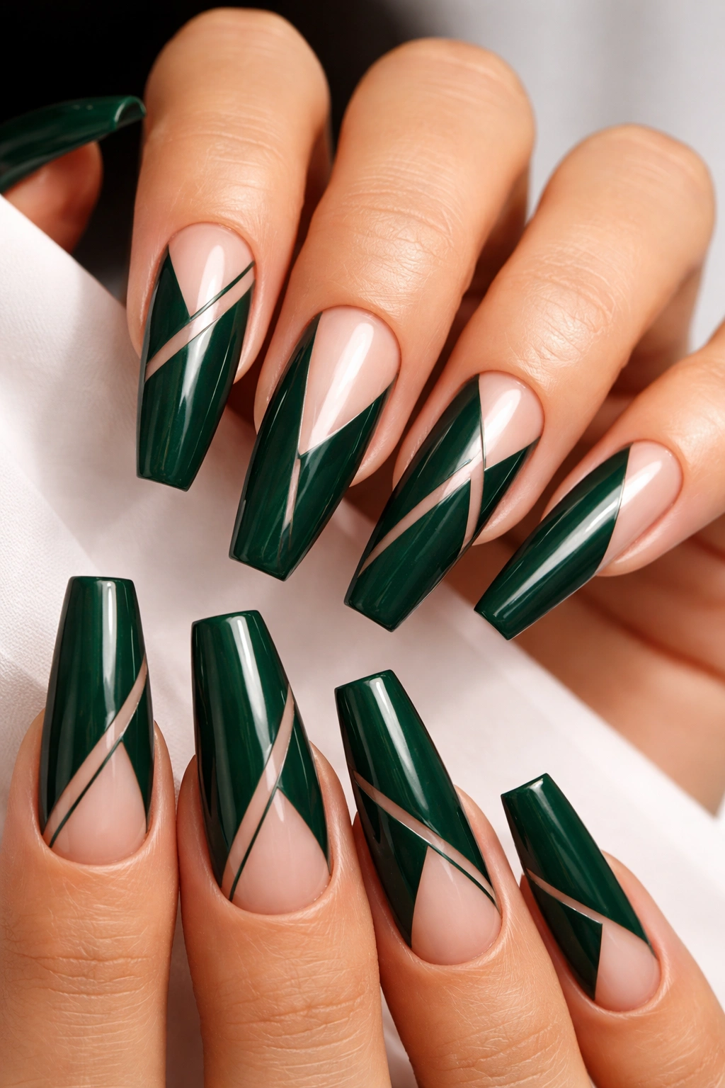 Close-up of dark green coffin nails with negative-space geometric patterns
