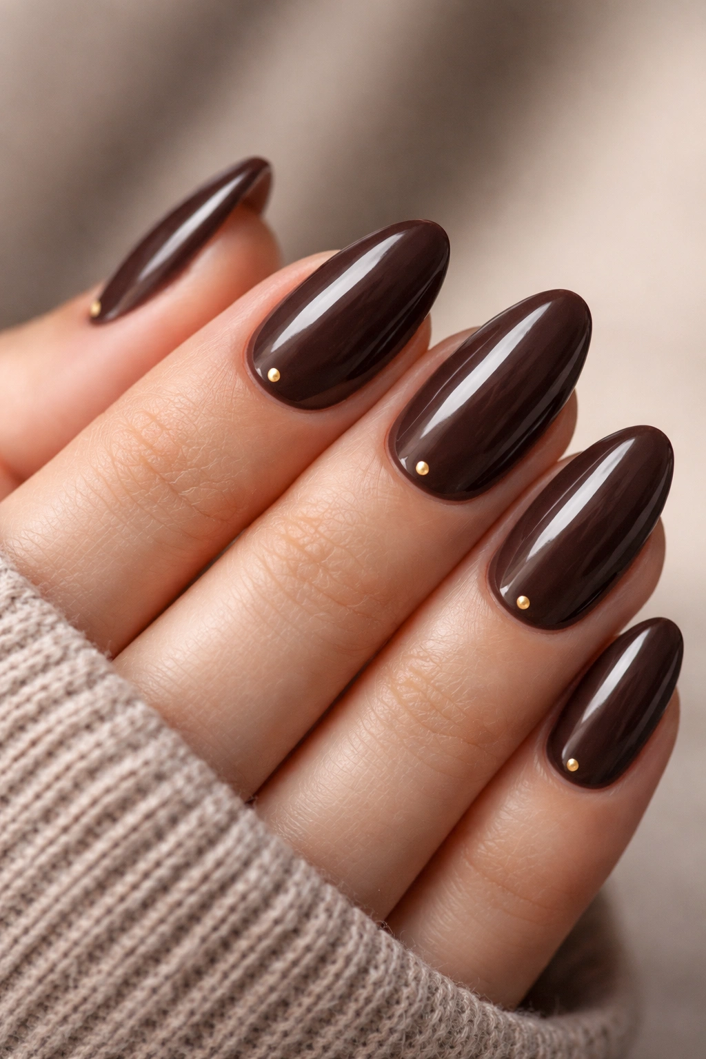 Short almond nails in dark mocha with tiny dot accents