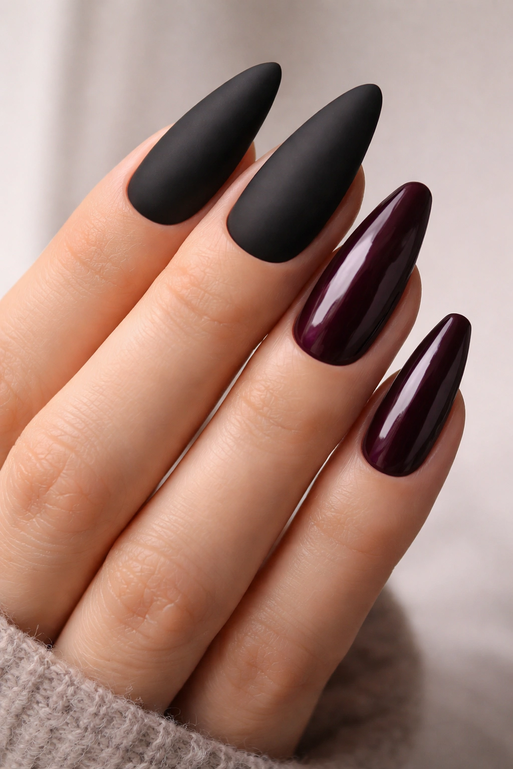 Close-up of nails showing matte black and glossy plum finishes to illustrate style pairing