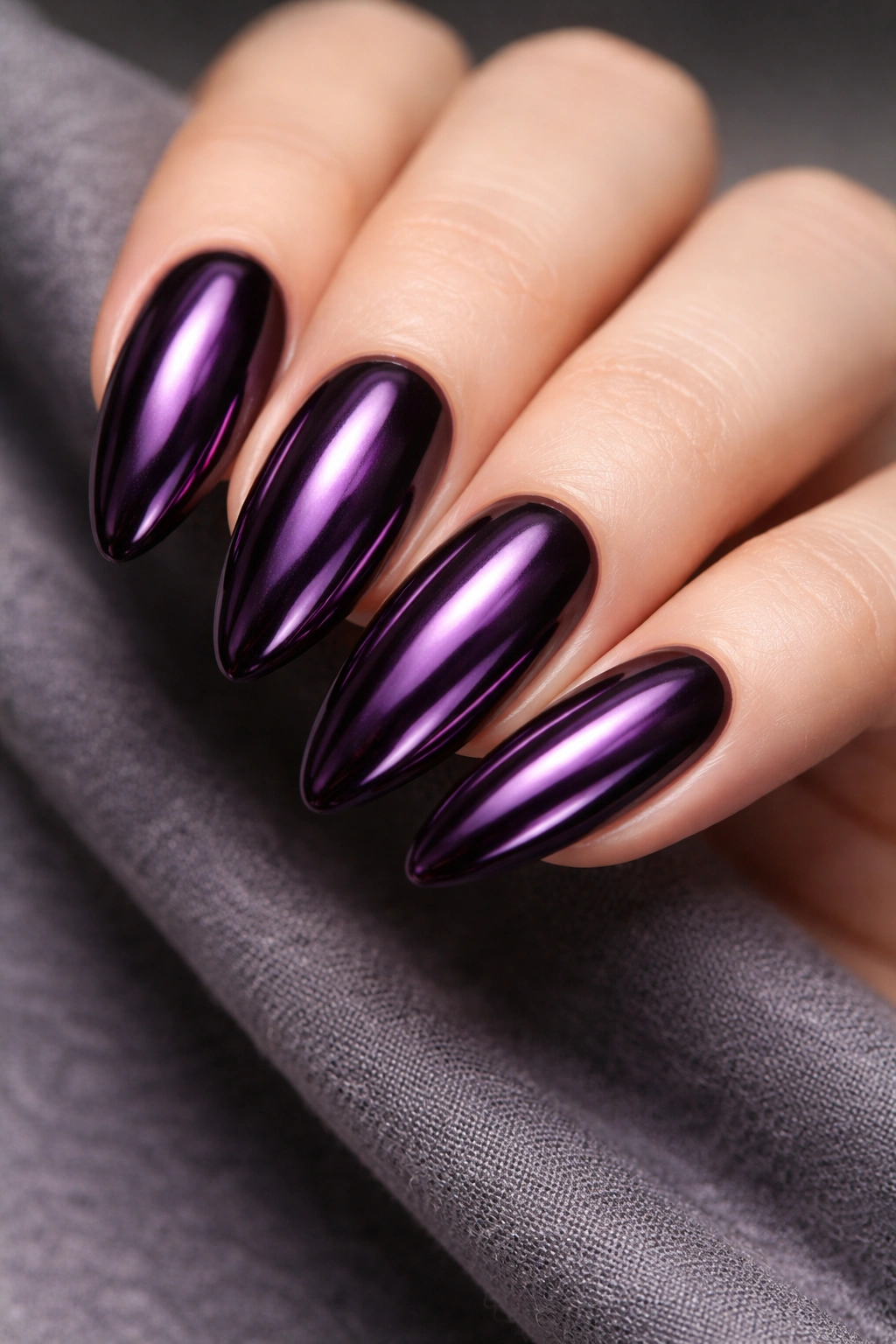 Dark purple chrome nails with deep metallic shine.