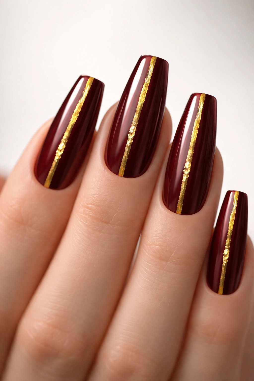 Coffin nails in dark red with gold foil accents