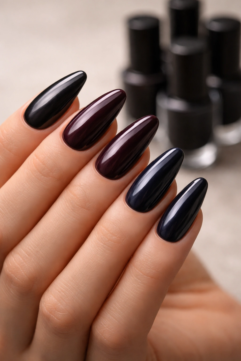 Close-up of hand with nails in a gradient of dark tones from charcoal to midnight blue