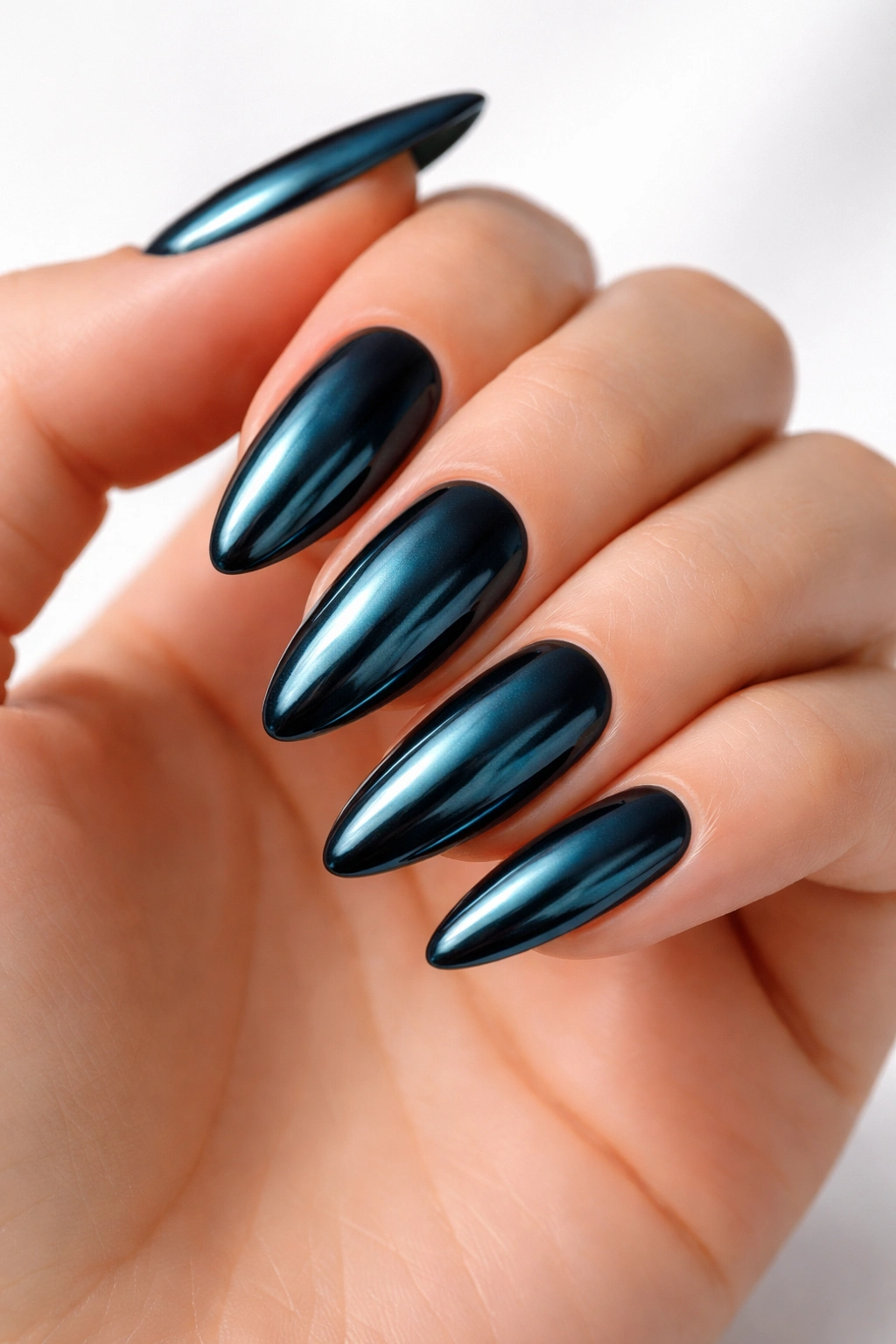 Almond nails with deep teal color and chrome mirror finish