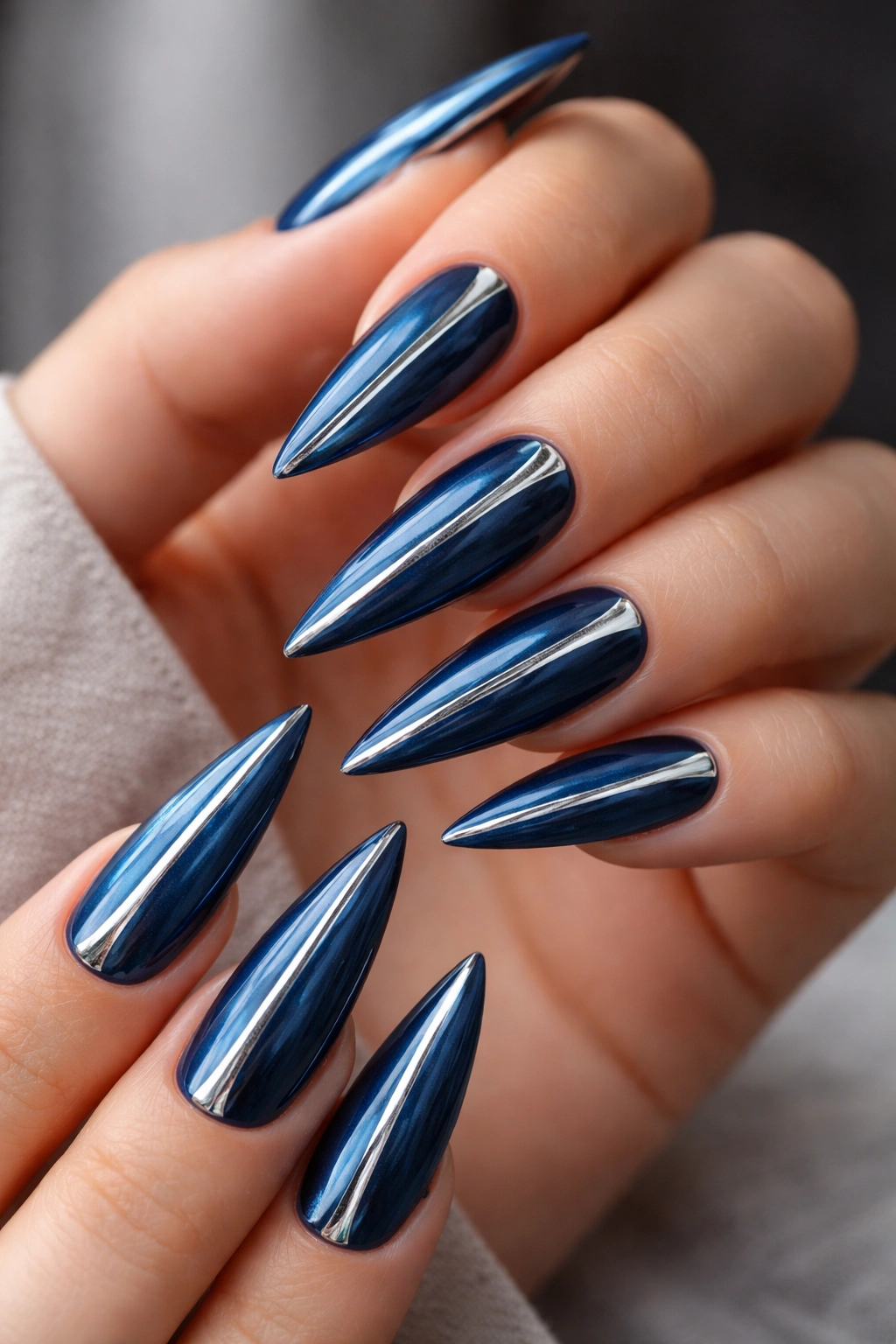 Deep ocean blue stiletto nails with silver foil accents