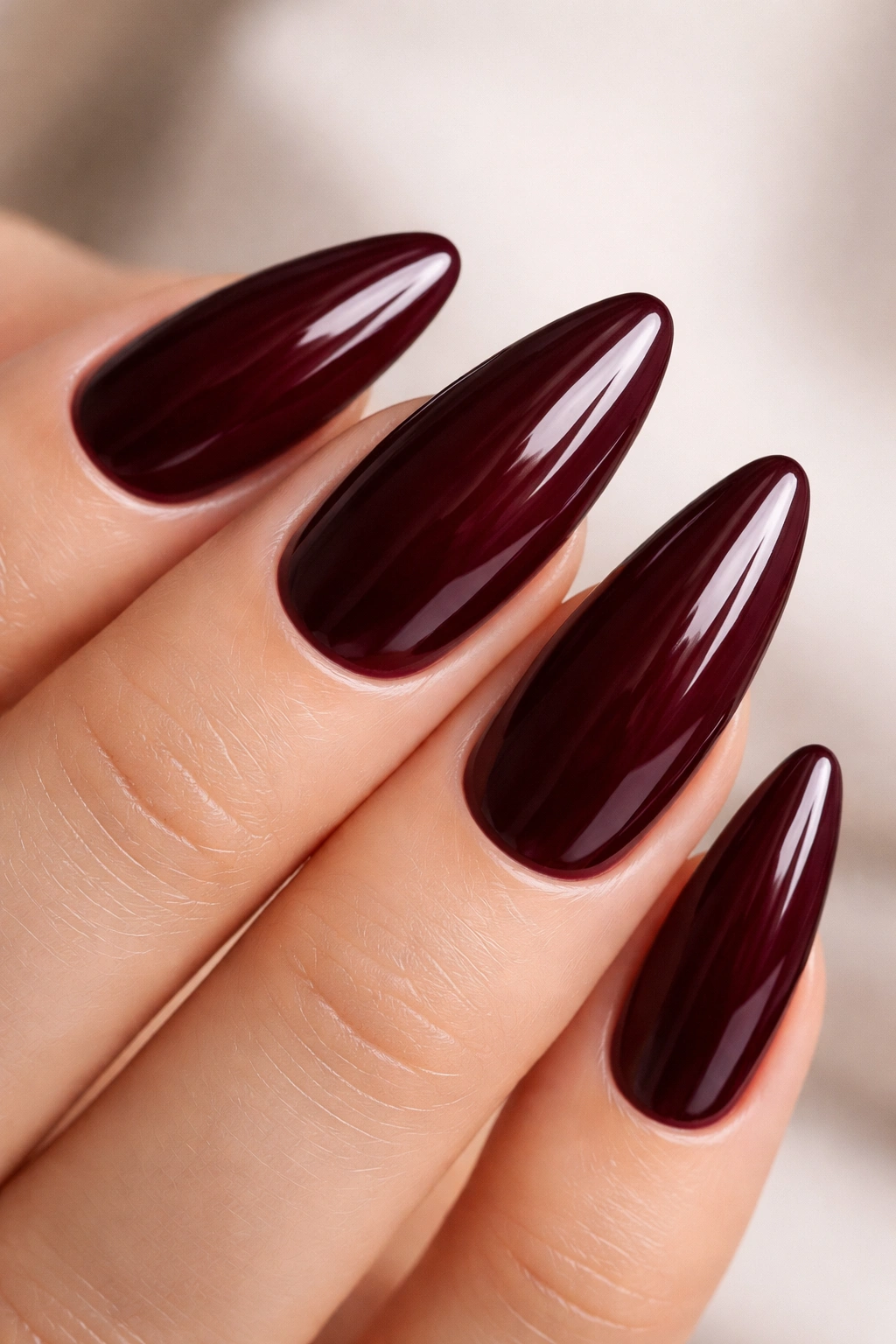 Almond nail in deep burgundy with glossy finish
