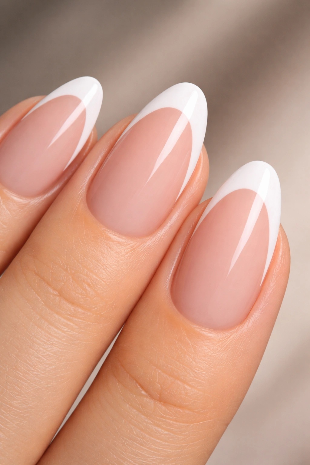 Close-up of almond-shaped short nail with a deep curved white smile line on the tip