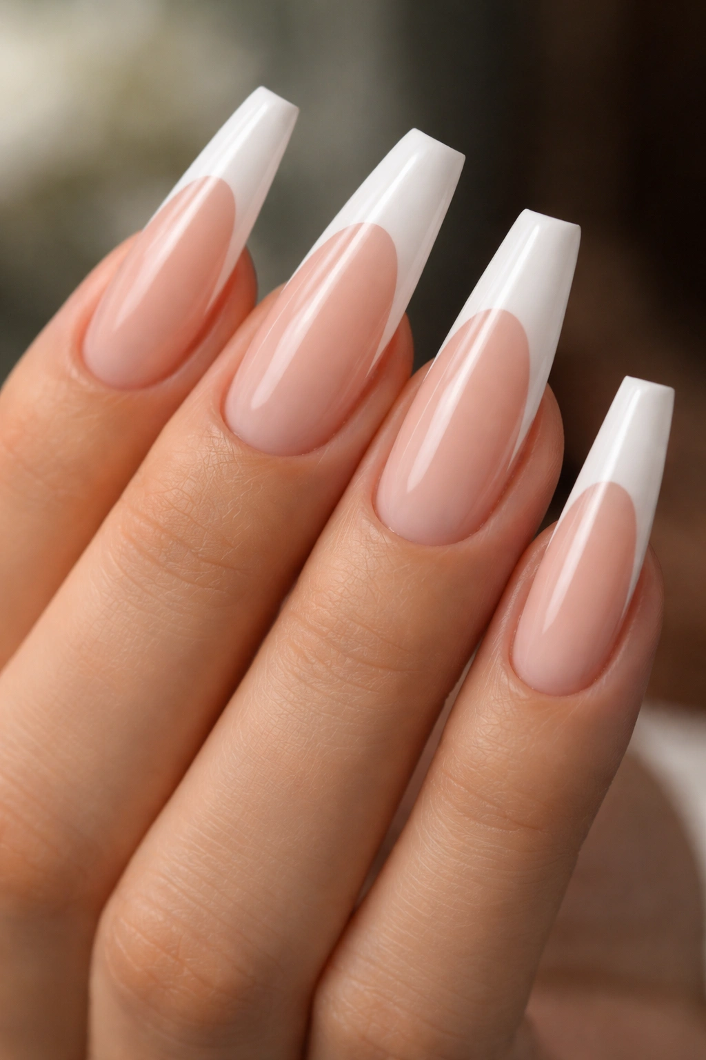 Long nude ballerina nails with deep curved white tips and crescent smile line