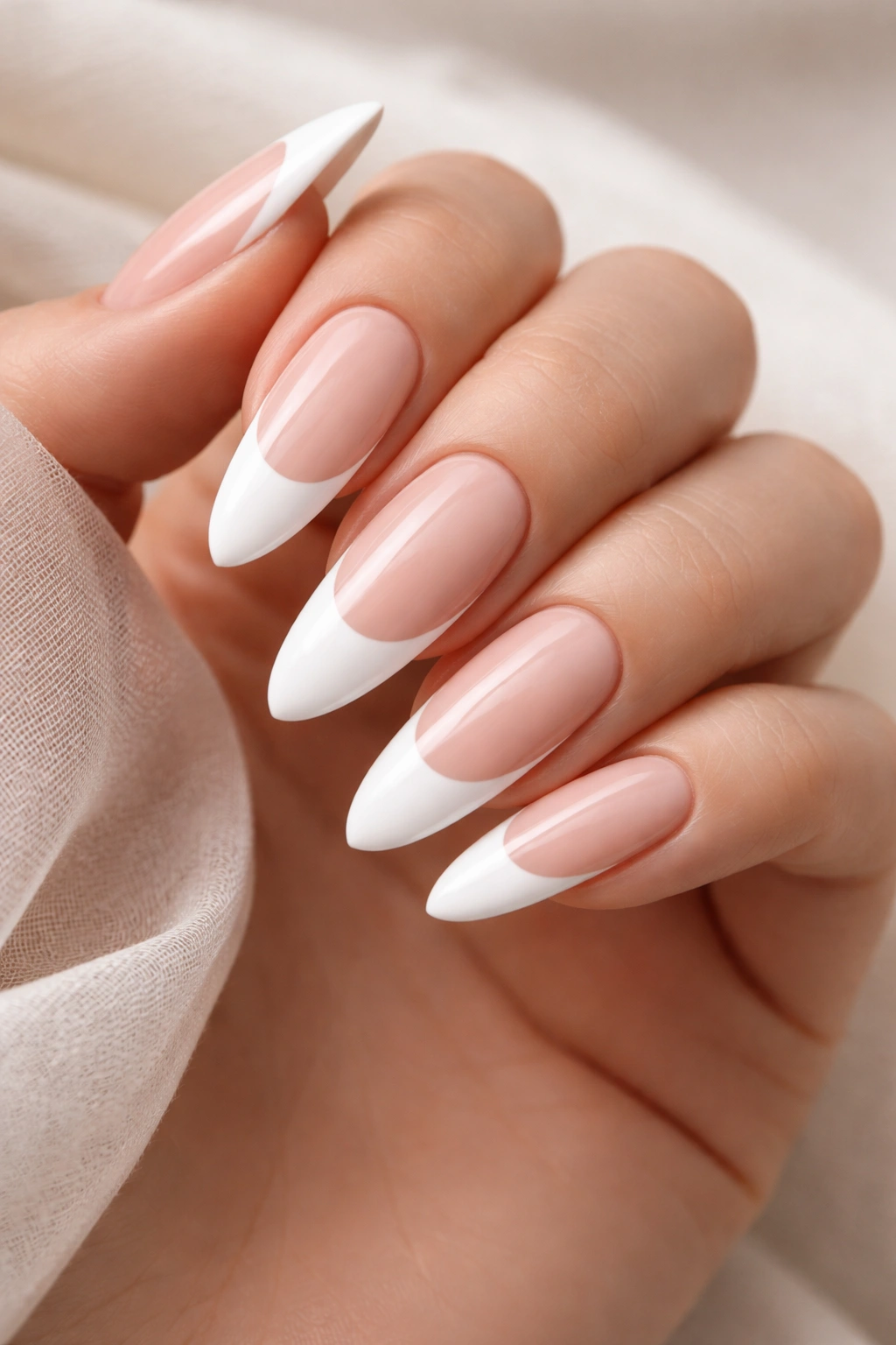 Almond-shaped nails with deep white French tips.
