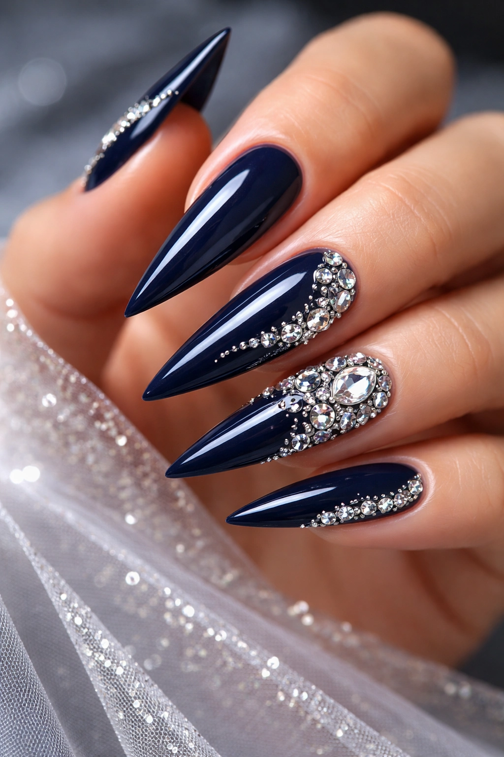 Deep navy nails with white and silver rhinestone accents