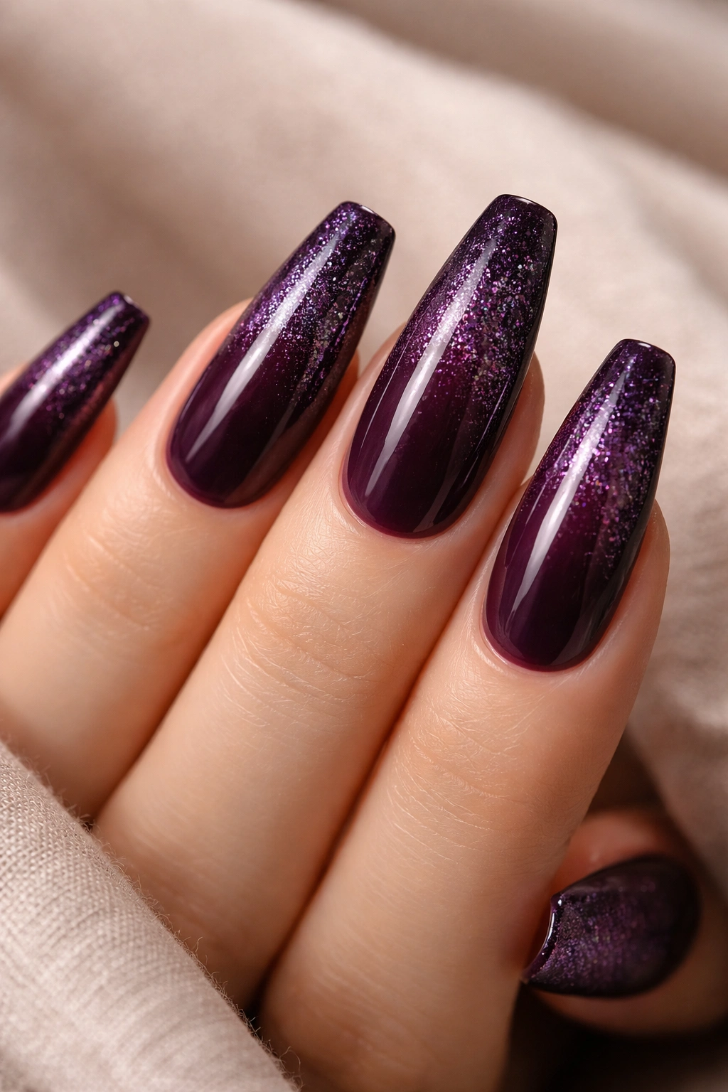 Deep plum coffin nails with sparkle gradient toward tips