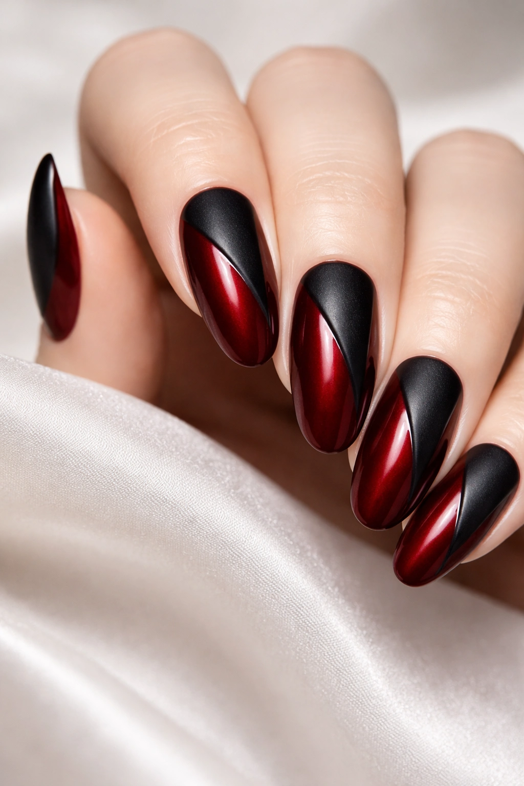 Deep red nails with black cat-eye details on long round nails, bold holiday look.