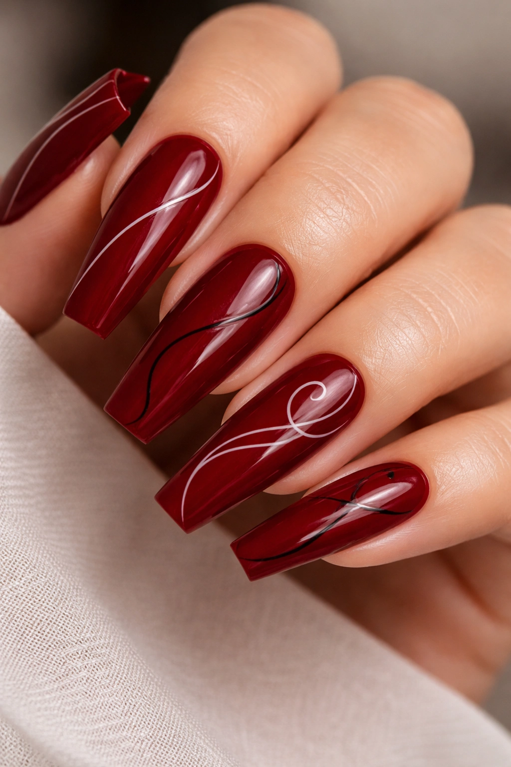 Deep red coffin nails with minimalist line art