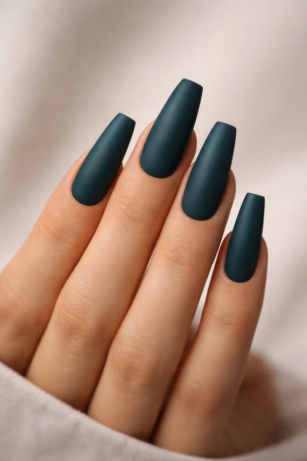 Deep teal matte coffin nails with soft texture on long nails