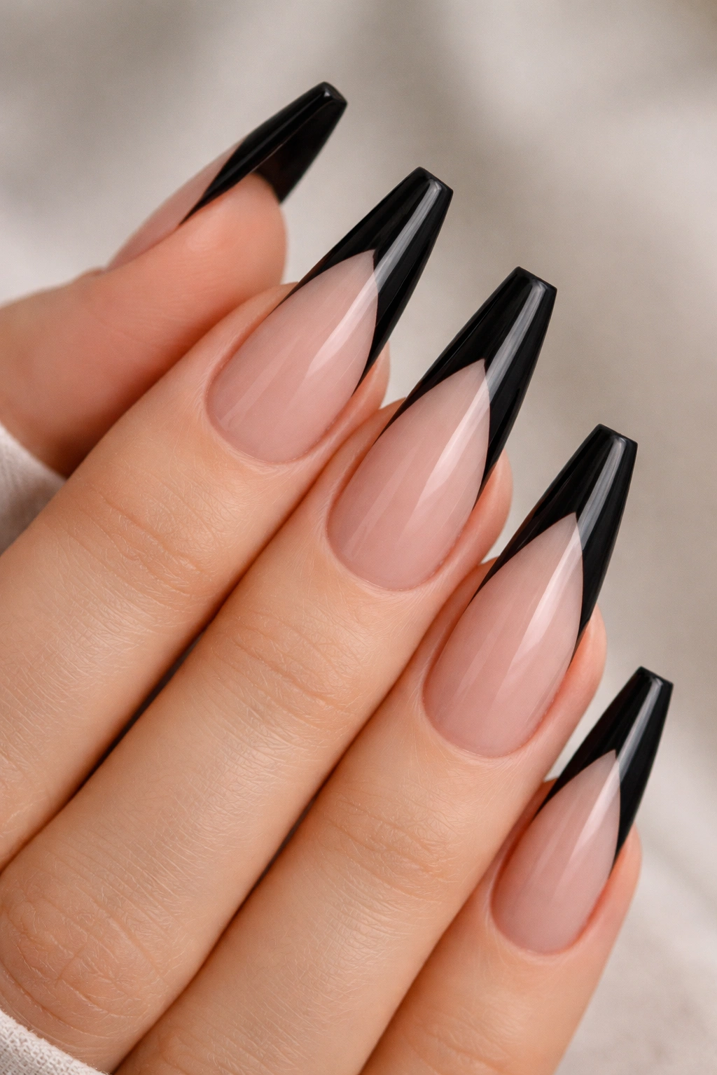 Long ballerina nails with deep V black tips and center point.