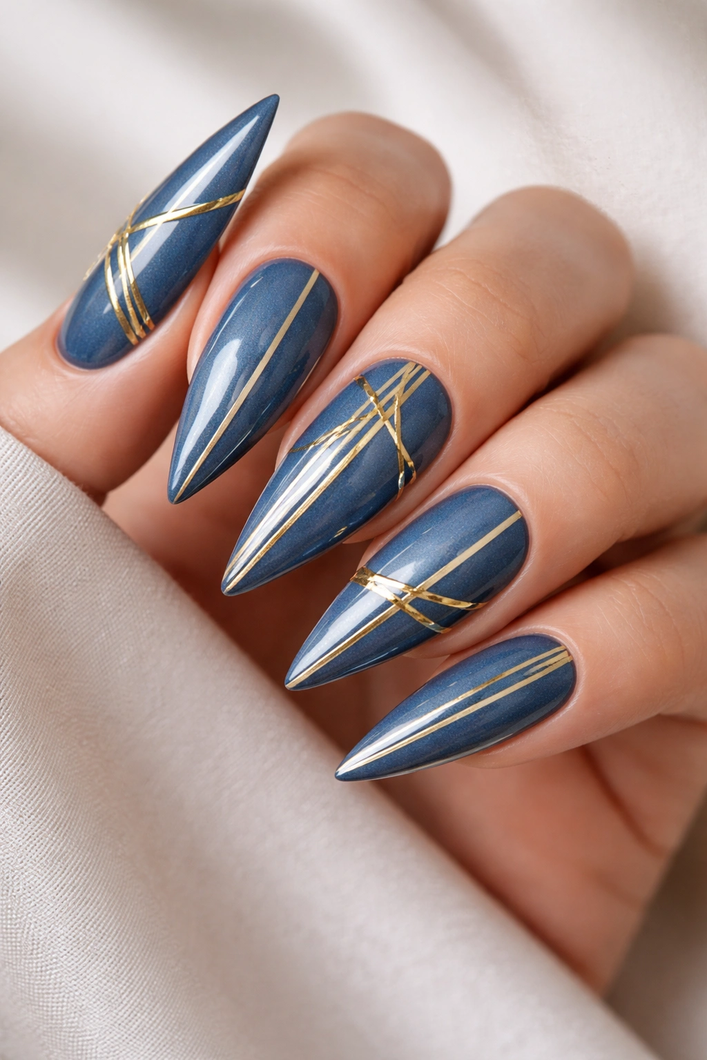 Denim blue nails with gold striping tape geometric design on stiletto nails