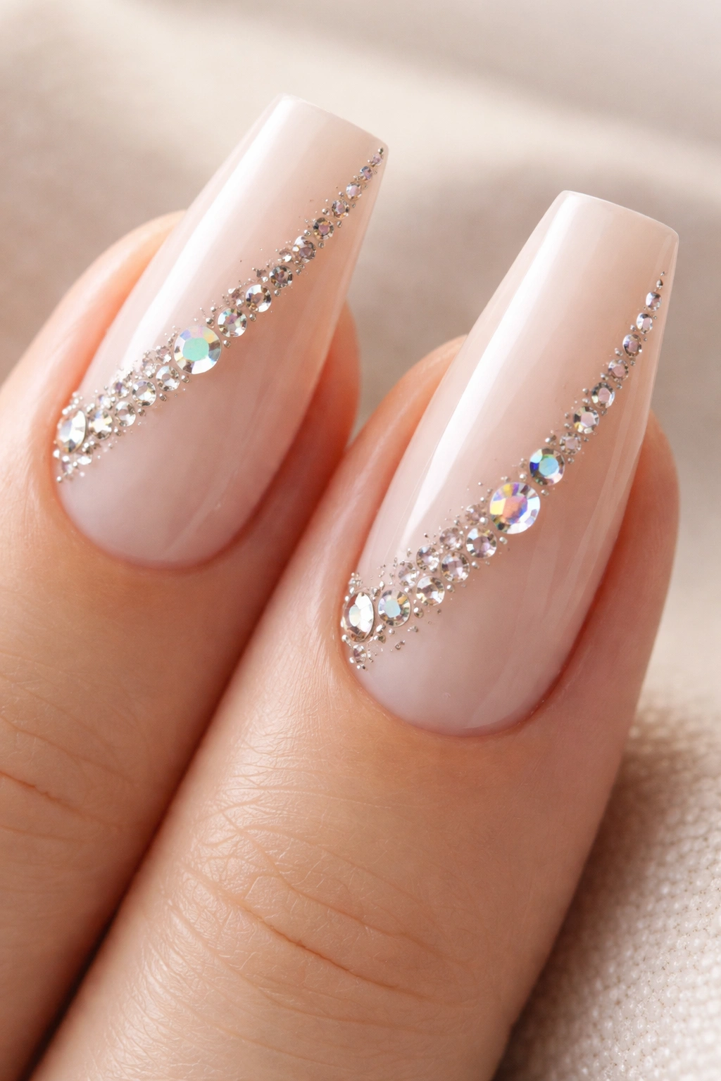 Diagonal crystal trail on milky nude coffin nails