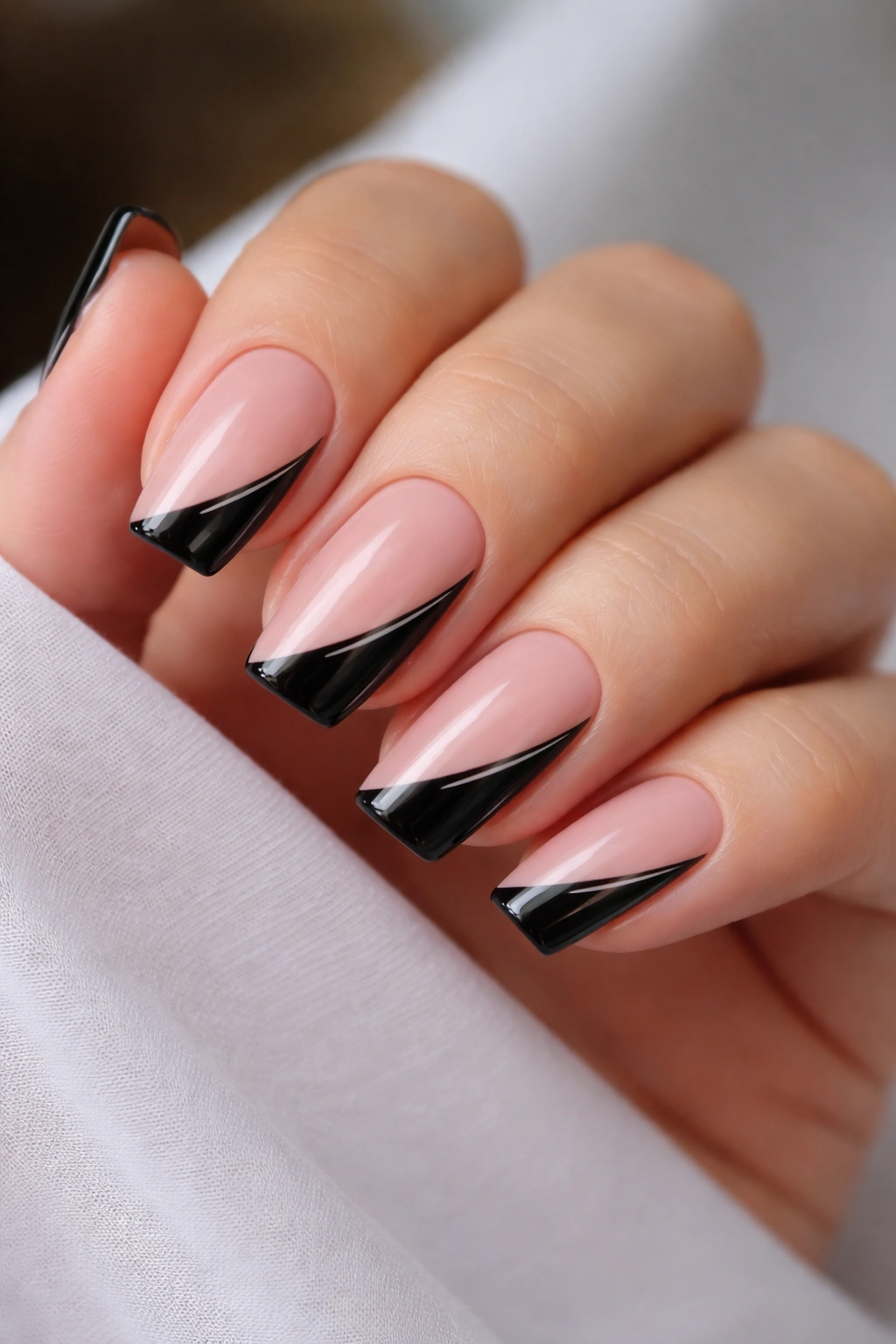 Short ballerina nails with diagonal black side French and tapered slash